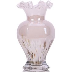 a clear glass vase sitting on top of a white table next to a silver base