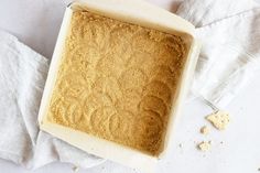 an uncooked cake sitting on top of a white table next to a napkin