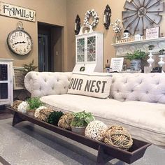 a living room filled with lots of furniture and decor on top of a wooden table