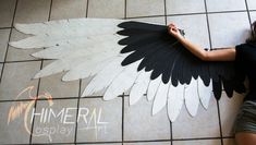 a woman is laying on the floor with an angel wing cut out to look like feathers