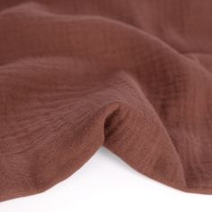 a close up view of a brown cloth on a white surface