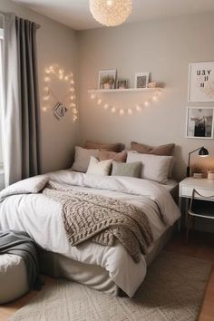 a bedroom with a bed, lights and pictures on the wall