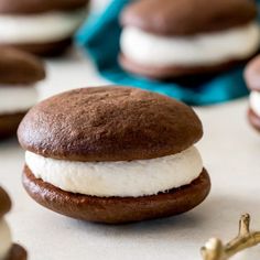 there is a chocolate sandwich with cream filling on the top and cookies in the background