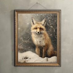 a painting of a red fox sitting in the snow on a wall hanging from a frame