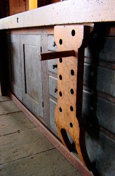 an old wooden bench with holes in it