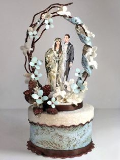 a wedding cake is decorated with an image of two people and flowers in the middle