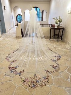 a wedding veil hanging from the side of a bridal gown