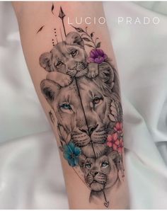 a woman's leg with a tattoo on it and two lions holding an arrow