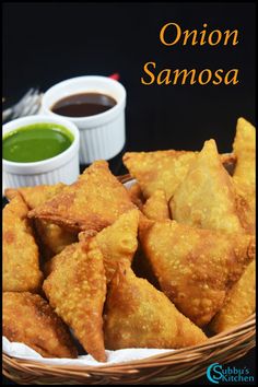 fried onion samosa in a basket with dipping sauce