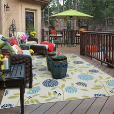 a deck with furniture and an umbrella on it