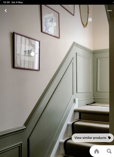 some stairs and pictures hanging on the wall