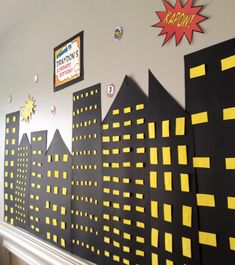 the wall is decorated with yellow and black paper cityscapes on it's sides