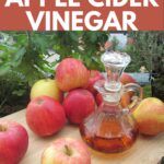 an apple cider vinegar is sitting on a cutting board