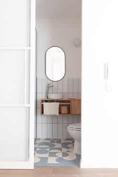 an open door leading to a bathroom with blue and white tile