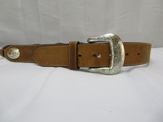 Tony Lama Belt, size 38 Vintage 1994 Some surface scratches on leather Silver needs polish All woven areas in good condition Belt measures approximately 45 inches from end of buckle to tip and is 1.5 inches Conch Belt, Tony Lama, Belt Brown, Leather Silver, Suspender Belt, Belt Size, Conch, Suspenders, Belts