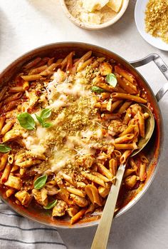 a pan filled with pasta and sauce on top of a table