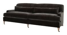 a black couch sitting on top of a white floor