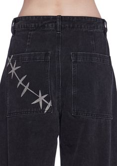 These wide leg jeans have a denim construction, a front graphic print of Chucky’s face, side pockets, D-ring hardware, back pockets with a stitch graphic print, and a front button and zipper closure. Edgy Black Flare Jeans With Pockets, Black Flare Jeans For Streetwear, Alternative Wide Leg Streetwear Jeans, Edgy Wide Leg Flare Jeans For Streetwear, Wide Leg Jeans For Alternative Fashion, Edgy Wide-leg Flare Jeans For Streetwear, Black Jeans For Concerts With Pockets, Black Denim Jeans For Concert, Grunge Black Wide Leg Flare Jeans