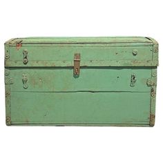 an old green chest with metal latches on the top and bottom, against a white background