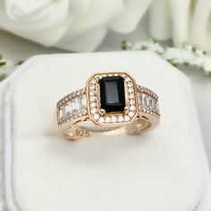 This beautiful ring is made from genuine 925 sterling silver with Rose Gold plating. Ring details- -The Main stone is an Emerald Cut 7mm by 5mm Natural Black Onyx Stone -Side stones are Round 1.1mm And 1.2mm simulated diamonds And 3mm by 1.5mm Baguette Simulated Diamonds -Ring is casted in solid 925 sterling silver with Rose Gold plating ( yellow gold and white rhodium plated also available, please check the drop down menu for more options) -The Total face height of the ring measures 11mms and t Classic Black Baguette Cut Rings, Black Baguette Cut Ring For Formal Occasions, Black Rectangular Jewelry For Wedding, Formal Black Baguette Cut Rings, Elegant Black Baguette Cut Ring, Elegant Black Baguette Cut Jewelry, Black Rectangular Stone Ring For Anniversary, Black Rings With Rectangular Stone For Anniversary, Luxury Black Emerald Ring For Anniversary