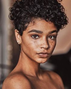 an image of a woman with freckles on her face and shoulders looking at the camera