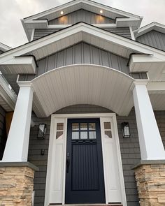 the front door of a house with white pillars