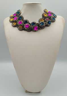 "These Anna Wintour style statement necklaces are made with beautiful rivoli crystals in a range of colours, there is 14mm Blue Zircon, 14mm Topaz and 14mm Fuchsia. The crystals are accentuated beautifully with the Black Diamond strass. You can wear them separately or layer them all together for full impact,  sure to get compliments and attention. Their versatility makes them perfect for parties and other celebratory gatherings. Quality of the stones and settings makes them a perfect candidate for becoming heirloom pieces. It is elegant, classy and very \"Anna Wintour style\". Each necklace is accompanied by a pair of coordinated \"FREE GIFT\" earrings. Crystals - 14mm Rivoli point back strass. Crystal Colour Blue Zircon and Black Diamond. Necklace length - Measures 16 inches. Crystals - 1 Party Jeweled Rhinestone Necklace, Party Rhinestone Jeweled Necklace, Round Crystal Necklaces For Party, Crystal Necklaces For Party, Multicolor Crystal Jewelry For Evening, Party Crystal Necklaces, Round Crystal Necklaces With Sparkling Stones For Party, Party Crystal Necklaces With Sparkling Stones, Jeweled Round Bridal Necklace For Party