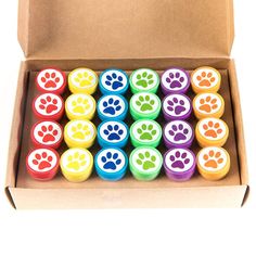 a box filled with different colored dog paw prints