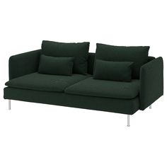 a green couch with pillows on it