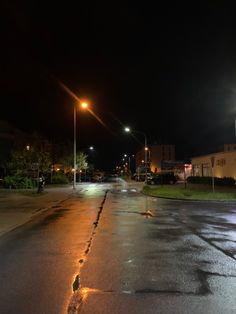 an empty street at night with no cars on it