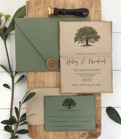 the wedding stationery is laid out on a cutting board with a wax stamp and envelope