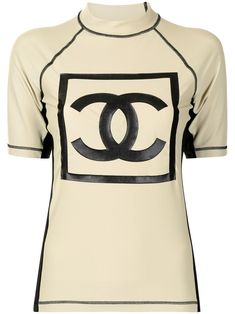 Beige/black 2003 Sports CC patch T-shirt from Chanel Pre-Owned featuring stretch-design, logo print to the front, logo print to the rear, side stripe detailing, contrast stitching, mock neck, short raglan sleeves, straight hem and circa 2003. POSITIVELY CONSCIOUS: Purchasing this item continues its narrative and reduces the environmental impact of using new resources. You can be confident that you’re making a better choice for the Planet.. Line Logo, Surf Design, Surf Tshirt, Shopping Chanel, Side Stripe, Black Logo, Black Stretch, Logo Print, Mock Neck