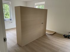 an empty room with hard wood floors and bare walls