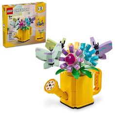 a lego flower pot with flowers in it and the box is open to reveal its contents