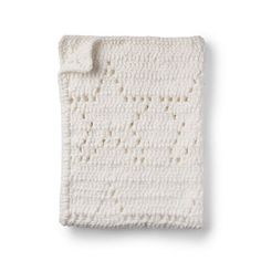 a white crocheted blanket on a white background