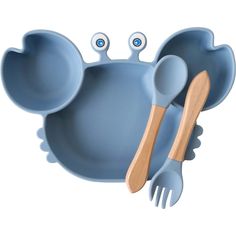 a blue dish with two spoons and a wooden utensil in the shape of an elephant