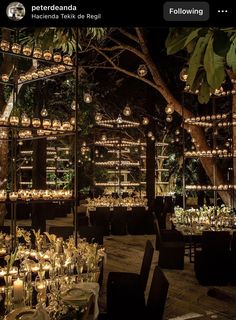 an outdoor dining area is lit up with candles