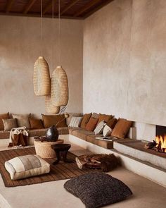 a living room filled with furniture and a fire place in the middle of the room