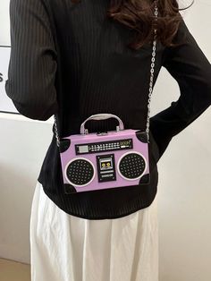 Introducing the Radiant Melody: Purple Radio Handbag, a trendy music-inspired crossbody bag. With its stylish design and convenient crossbody strap, this bag is perfect for carrying all your essentials while adding a touch of music to your outfit. Made from high-quality materials, it is both durable and fashionable. Elevate your fashion game with this must-have accessory. Color : Purple Details : Chain, Spiked Type : Novelty Bag, Square Bag, Box Bag, Camera Bag Bag Size : Mini Closure Type : Buc Trendy Rectangular Bag For Concerts, Trendy Rectangular Shoulder Bag For Concert, Trendy Rectangular Shoulder Bag For Concerts, Trendy Shoulder Bag For Concerts, Crossbody Bag With Adjustable Strap For Concerts, Trendy Music, Purple Details, Trendy Handbags, Novelty Bags