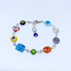 "The beautiful patterns in this Millefiori bracelet pair well with so many styles; the bright, floral designs create unique results with each custom order. This colorful jewelry piece makes a memorable gift with an optional monogram charm, or treat yourself just because. This bracelet has quality, handcrafted .925 sterling silver bead chain with varying Millefiori glass patterns and a great multicolor appeal. Millefiori or \"thousand flowers\" glass art is an ancient technique practiced by lampw Adjustable Multicolor Nickel-free Jewelry, Trendy Multicolor Charm Bracelet, Bohemian Multicolor Nickel-free Charm Bracelet, Handmade Adjustable Multicolor Charm Bracelet, Handmade Multicolor Adjustable Charm Bracelet, Adjustable Multicolor Handmade Charm Bracelet, Vibrant Rainbow Jewelry With Colorful Design, Rainbow Flower-shaped Jewelry For Gifts, Trendy Multicolor Flower Jewelry