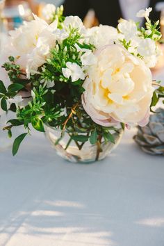 a vase filled with white flowers on top of a table