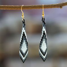 Handcrafted by artisan Angeles Gonzalez from Mexico, these gorgeous feather-shaped dangle earrings are perfect to complement any outfit. Angeles places each glass bead meticulously to form a black and white geometric pattern that embellishes these elegant earrings with 14k gold-plated hooks. Beaded Feather Pattern, Black And White Beaded Earrings, White Beaded Earrings, Black And White Geometric Pattern, Native Beading Patterns, Brick Stitch Earrings, Buy Bead, Feather Pattern, Art Pendant