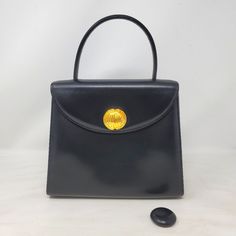 Vintage Givenchy Classic Kelly Top Handle Bag In Very Good Pre-Owned Condition! Guaranteed Authentic Or 100% Your Money Back! Key Features Color: Black Exterior: Made By Smooth Calfskin Leather Gold Tone Hardware Snap Closure, The Button Is In Two Styles, Is Interchangable Back Pocket The Handle Is Made By Leather, Handle Drop 4in. Interior: One Zipper Pocket, Fully Lined By Fabric Size: W 9.3in. X H 8in. X D 3.5in. In Medium Size, Good To Carry Daily Essentials Made In Japan No Dust Bag Conditi Givenchy Top, Vintage Givenchy, Givenchy Bag, Black Exterior, Medium Tote, Daily Essentials, Handle Bag, Hand Bag, Leather Handle