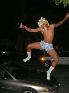 a shirtless man is jumping in the air