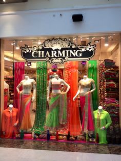 mannequins are displayed in front of a clothing store