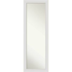 a white door with a mirror on the front and bottom panel, in an empty room