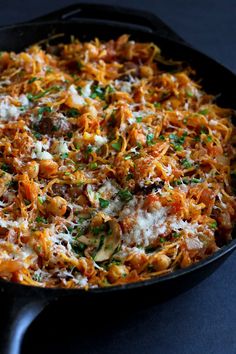 a skillet filled with pasta and cheese