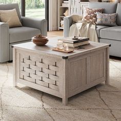 a living room with two couches and a coffee table in the middle of it