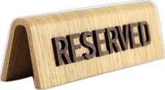 a wooden business card holder with the word reserved engraved on it's front side