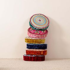 a stack of multicolored headbands sitting on top of each other in front of a white wall